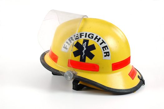 Yellow firefighters helmet isolated on a white background.