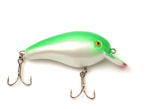 Green and white fishing lure on a white background.