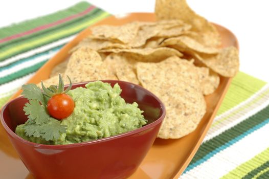 Bowl of fresh guacamole and crisp tortilla chips.