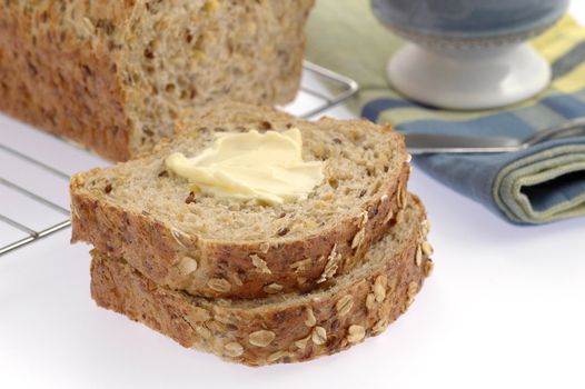 Slices of homemade hearty bread with butter.