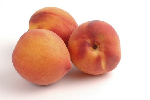 Fresh ripe peaches on a white background.