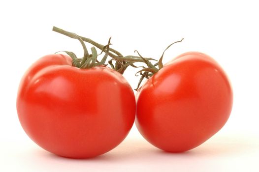 Ripe red tomatoes on a white background.