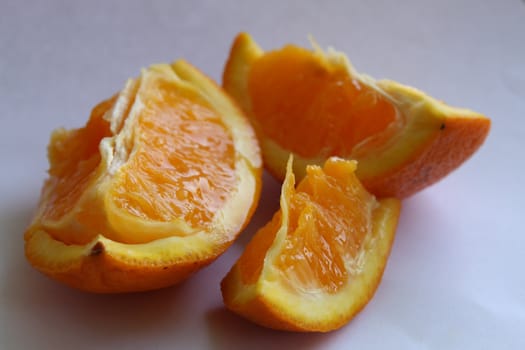 Three vivid juicy slices of orange