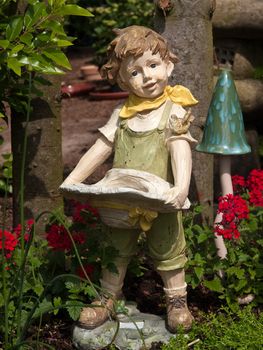 Garden gnome dwarf statue of a boy made from wood