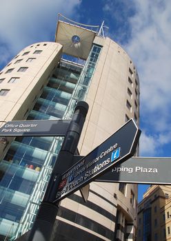 Sign post outside on modern building in city center