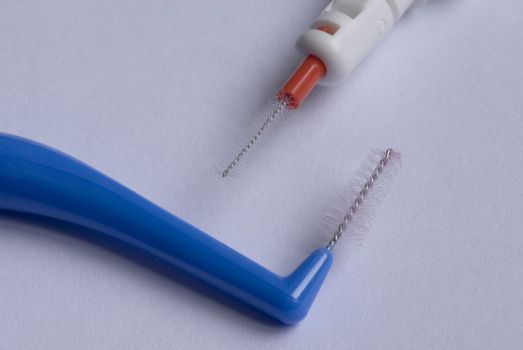 close up on two interdental tooth brushes