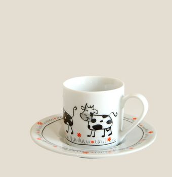 white cup for espresso with picture of cow on it