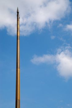 bare flagstaff against blue sky