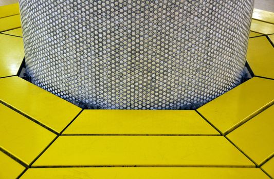 Rounded yellow bench around brown tiled pillar