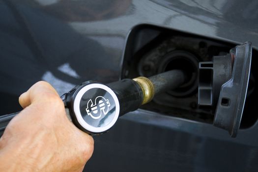 Man filling up the tank of his car. Horizontal shot.