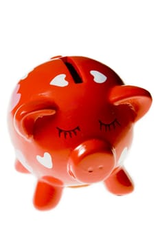 Red pig moneyboxe isolated on a white background.