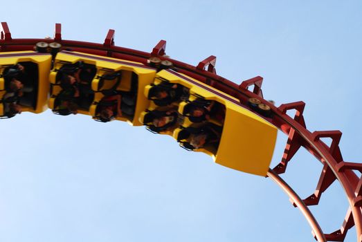 Roller Coaster with people taking a ride.