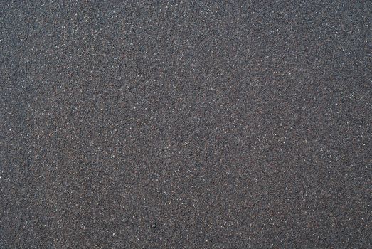 Sand texture or backround.  Wet black volcanic sand from Iceland