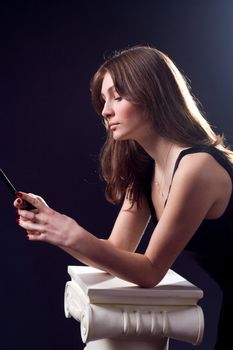 lady in black handing mobile phone
