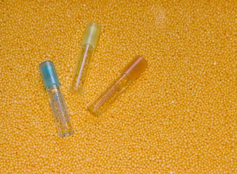 The image of three bottles lying on a yellow background