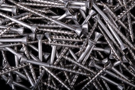A pile of wood screws, background