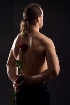 standing man with red rose
