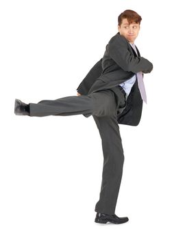 Businessman showing a karate kick, isolated on a white background