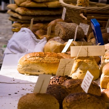 This is a close-up of various types of bread on a market stand in Surrey, UK