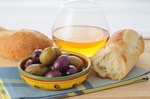 Dish of black and green olives with fresh bread.