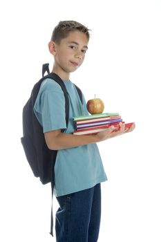 a boy with a rucksack and a pile of books and a healthy apple