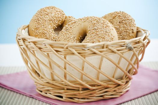 Breakfast bagels on the kitchen table over blue background