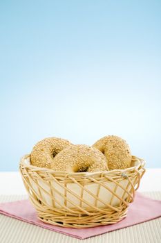 Breakfast bagels on the kitchen table over blue background