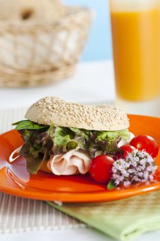 Breakfast bagels on the kitchen table over blue background