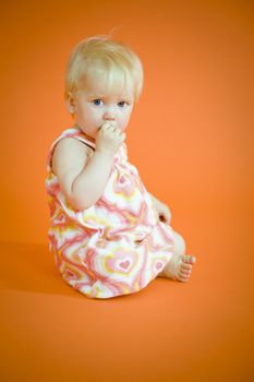 Small baby girl sitting on the floor