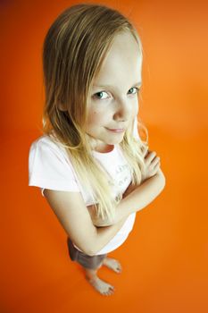 Funny shot of young girl over orange background