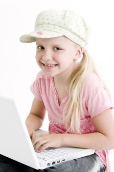 Young girl using a laptop computer over white background