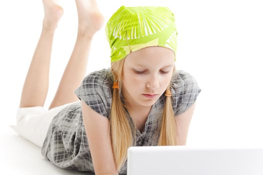 Young girl using a laptop computer over white background