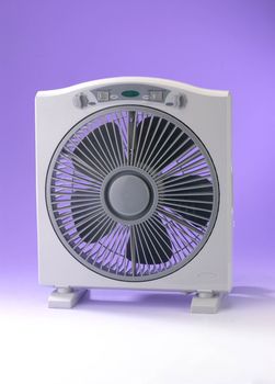 Modern desk cooling fan over white and purple background.
