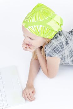 young girl with laptop computer on the white floor