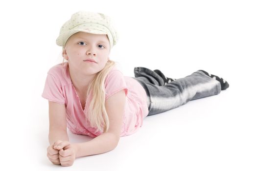 Young girl laying on the floor over white background