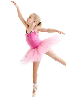 Young ballerina standing on pointe in toe shoes