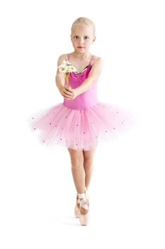 Young ballerina standing on pointe in toe shoes