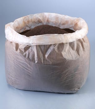 Pile of soil in a plastic. Gardening image. 
