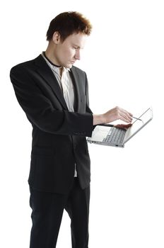 Isolated young businessman using a touchscreen laptop
