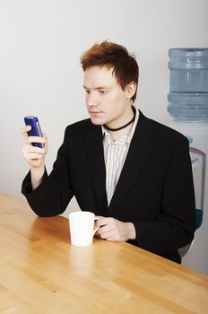 Businessman with coffee cup and mobile phone