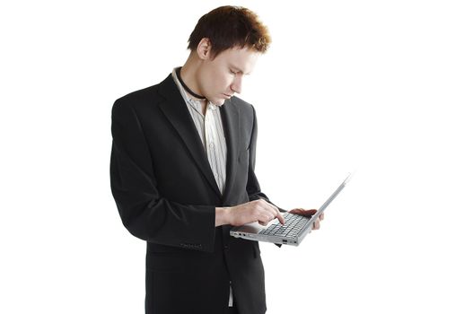 Isolated young businessman using a laptop computer