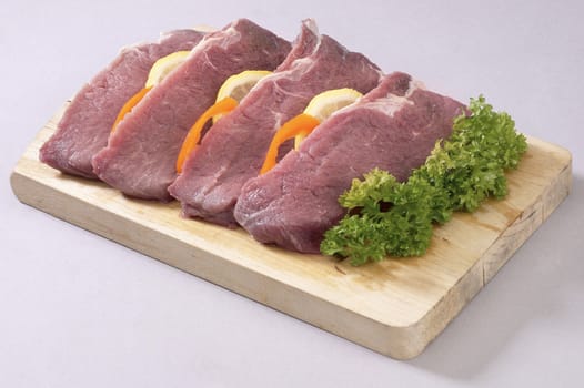 A selection of meat decorated with other ingredients.