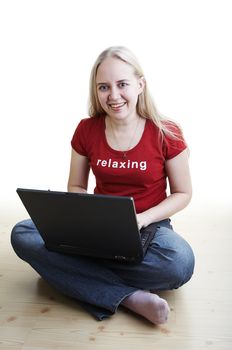 Girl sitting on the floor and use laptop computer