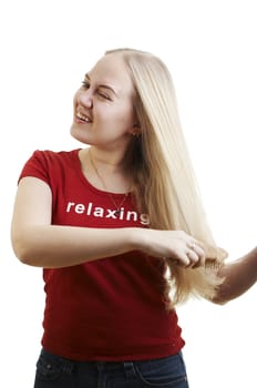 Girl brushing her hair on white background