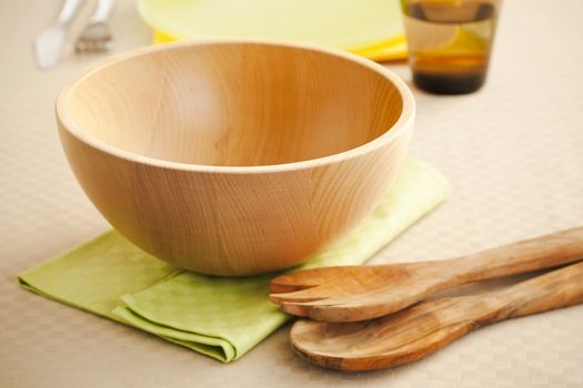 Empty wooden salad bowl on the kitchen table