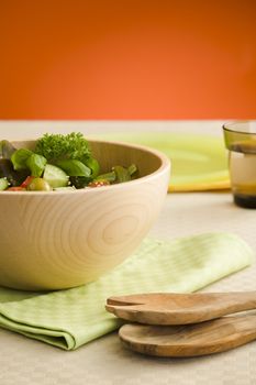 Fresh salad made from lettuce, tomotaoes, cucumber on the kitchen table