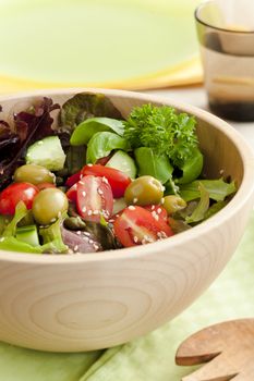 Fresh salad made from lettuce, tomotaoes, cucumber on the kitchen table