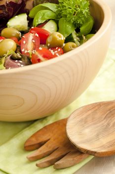 Fresh salad made from lettuce, tomatoes, cucumber on the kitchen table