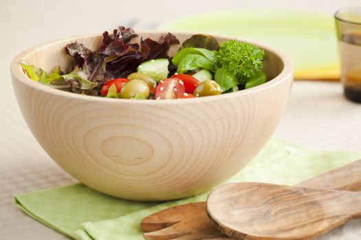 Fresh salad made from lettuce, tomotaoes, cucumber on the kitchen table