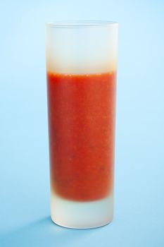Strawberry smoothie over a light blue background